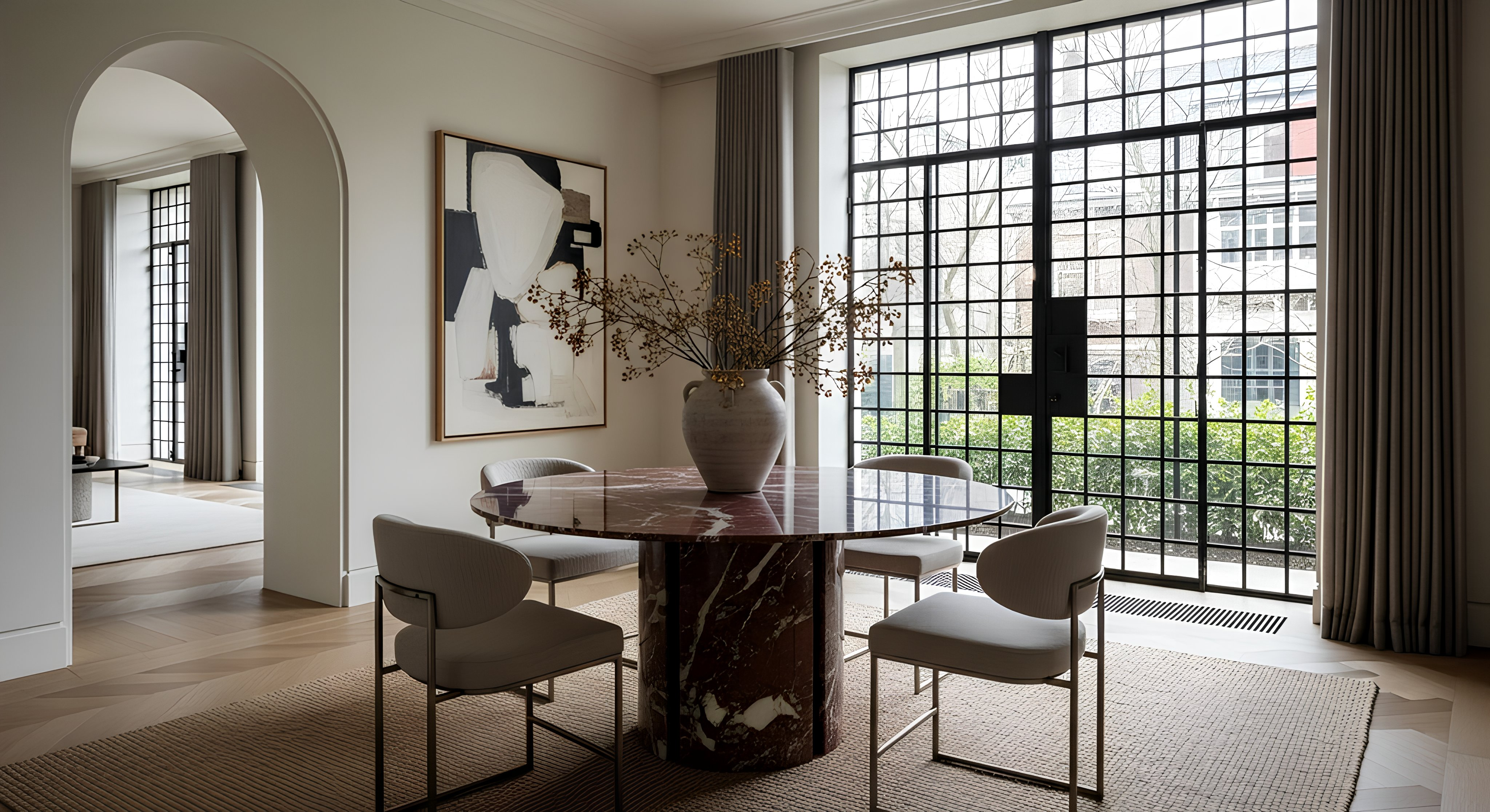 rosso levanto marble dining room with a large window, round table, and chairs.